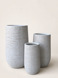 Set of textured fiber clay designer planters in light gray with rounded cylindrical shapes