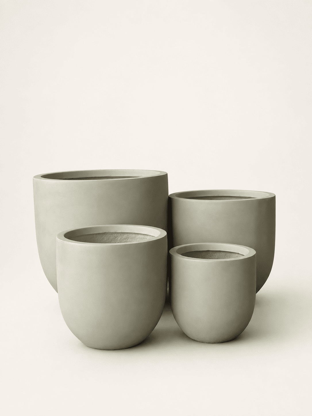 Set of four matte fiber clay planters, round rims, stacked sage-green