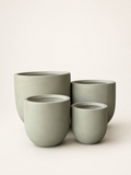 Set of four matte fiber clay planters, round rims, stacked sage-green