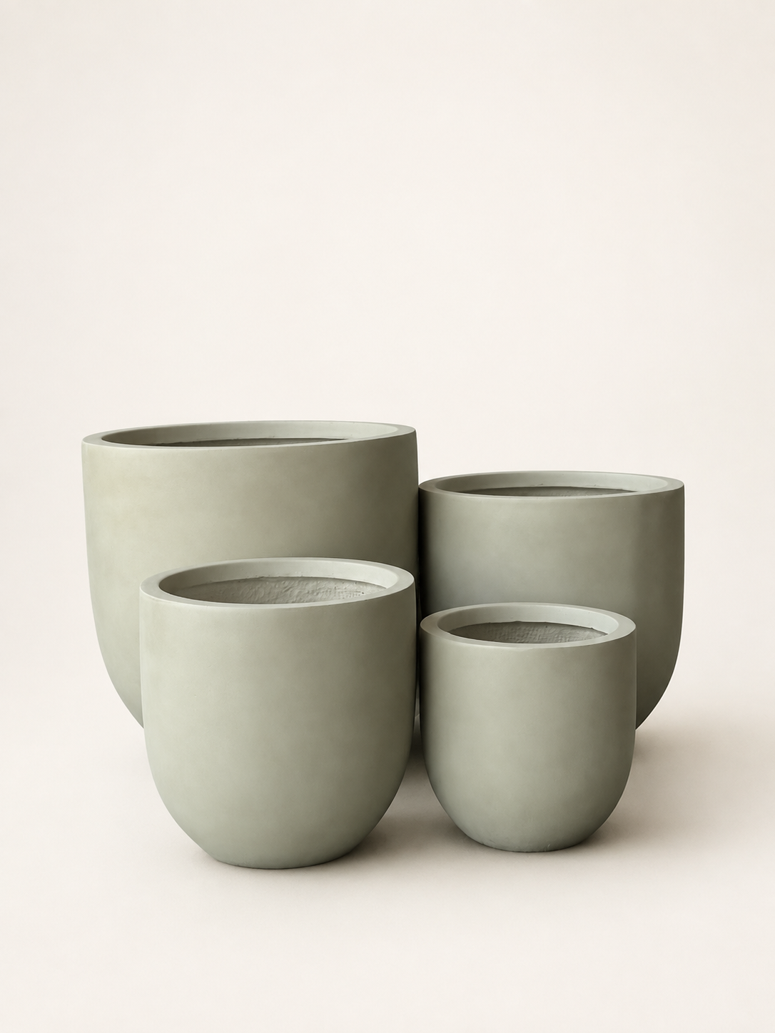 Set of four matte fiber clay planters, round rims, stacked sage-green