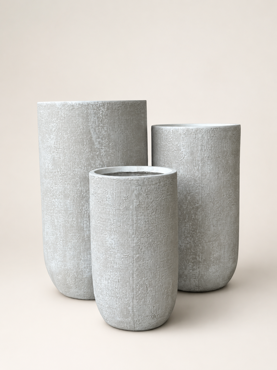 Textured cylindrical planter set, three light gray planters