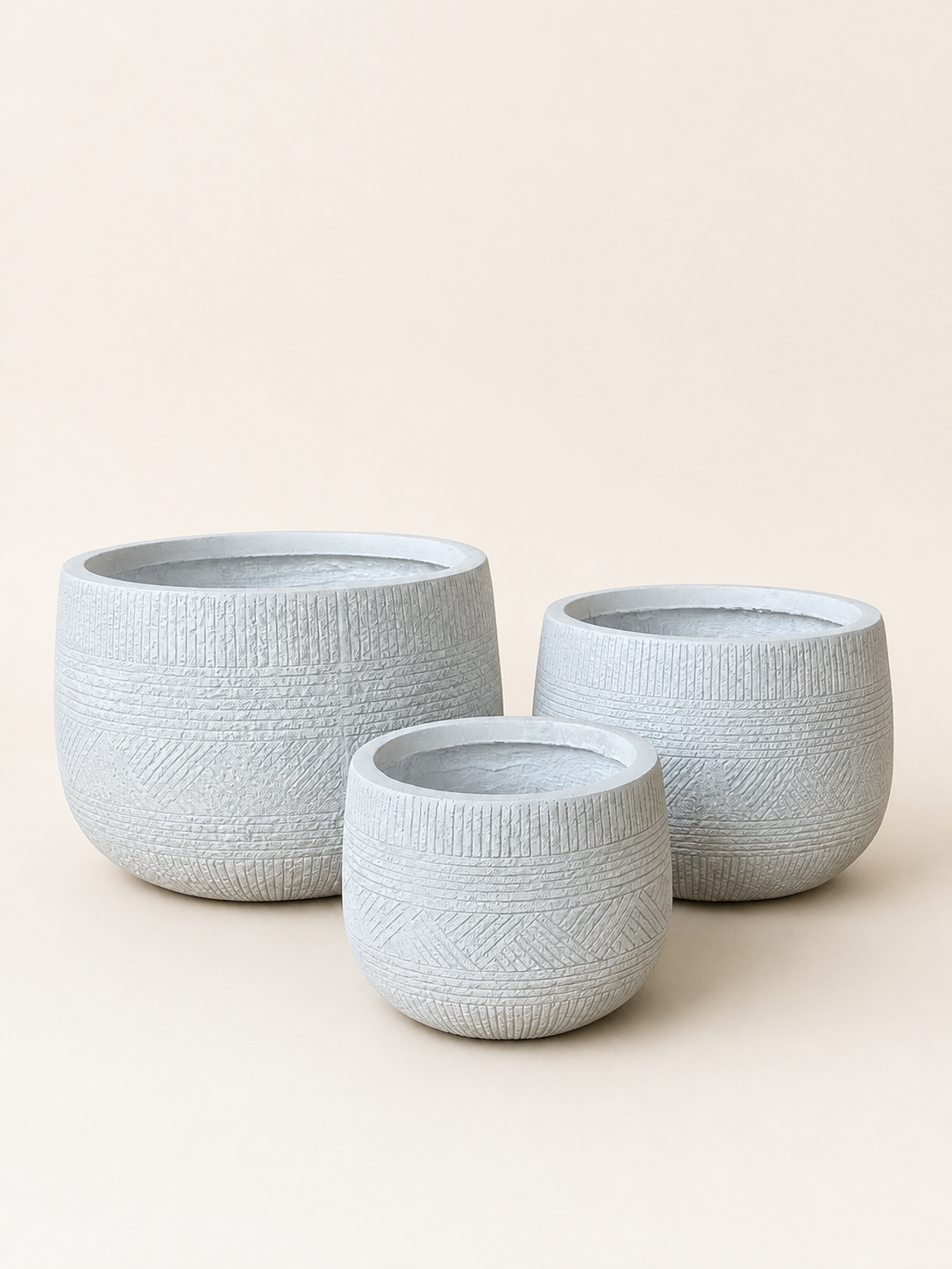 Set of textured white fiber plant pots, three round cylinders in varying sizes