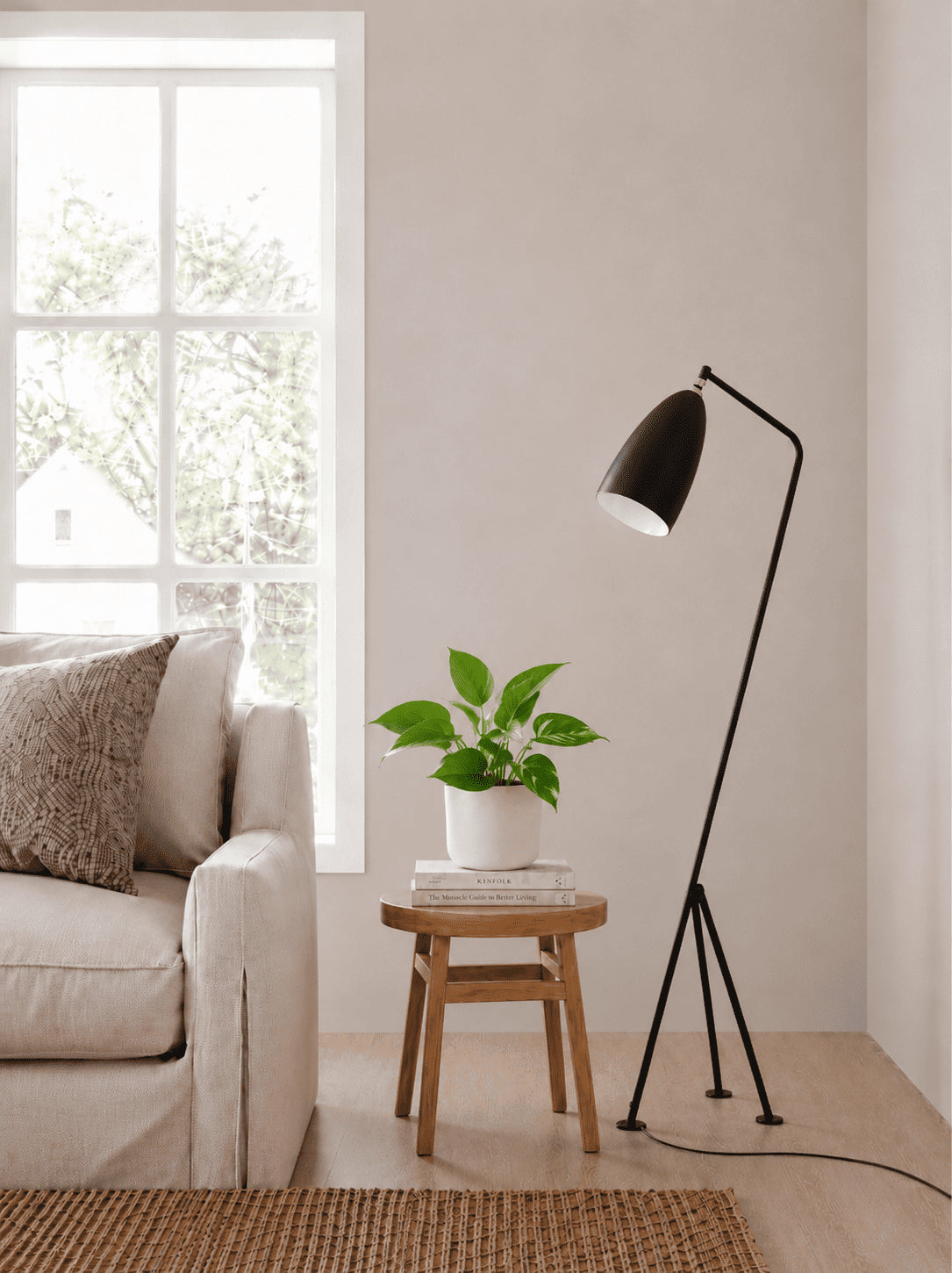 Golden pothos plant in a white pot, glossy green leaves on wooden stand