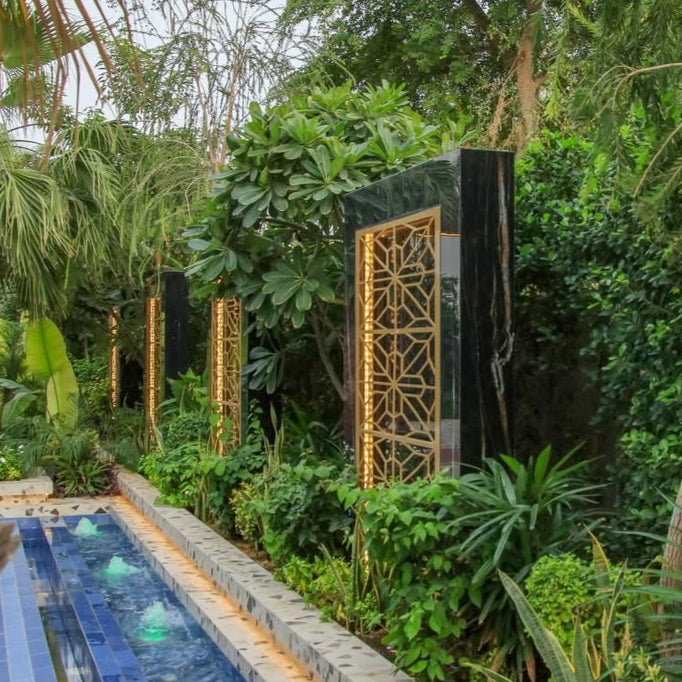 Decorative water feature with geometric design in a lush garden setting