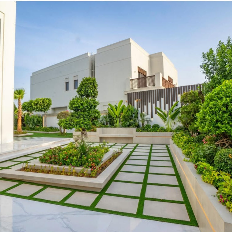 Modern house with a well-maintained garden and patio area.