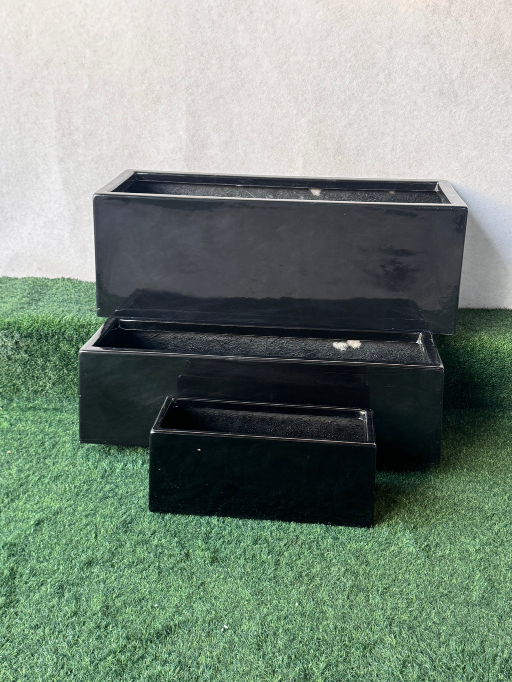 Rectangular black fiberglass planters in nested stack, three pieces