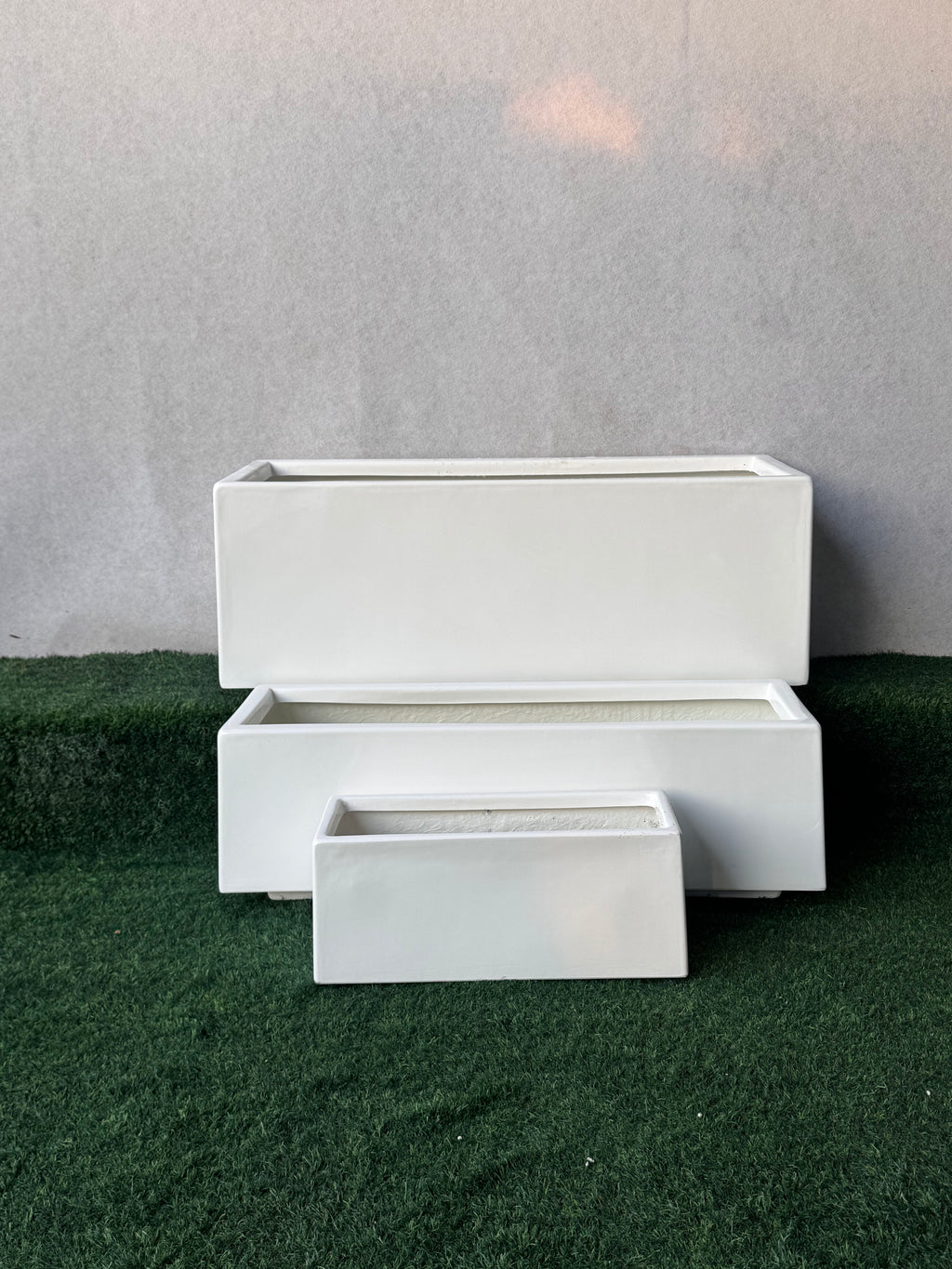 White rectangular long fiberglass planter pot with open top and inner tray