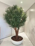 Artificial olive tree with leafy green canopy and brown trunk in a white planter pot