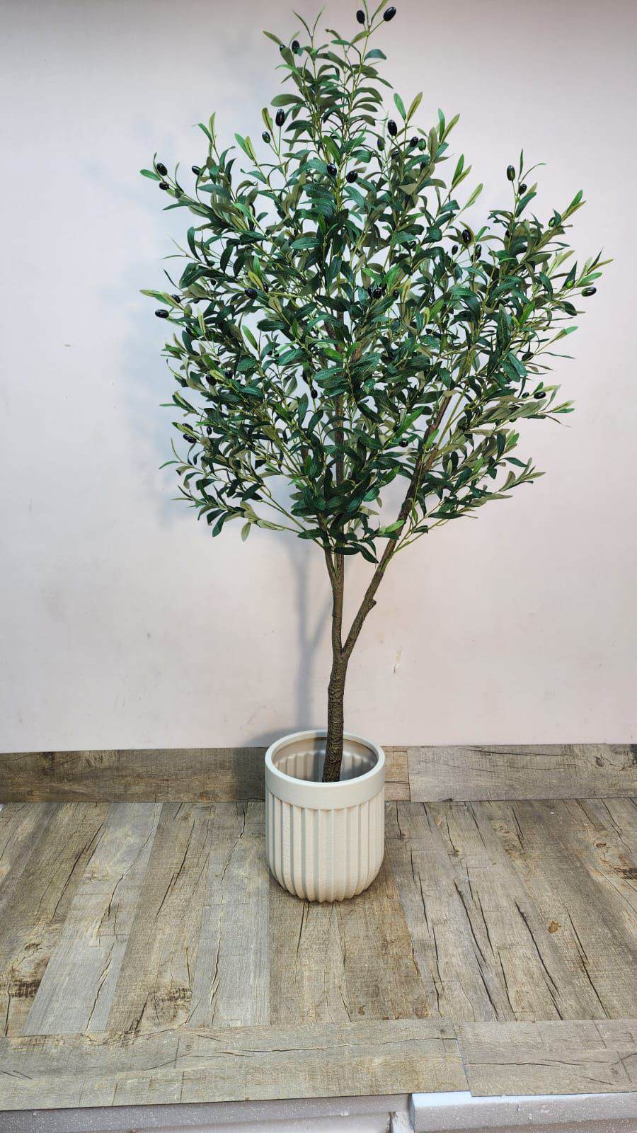 Artificial olive tree with dense green leaves in a white ribbed pot