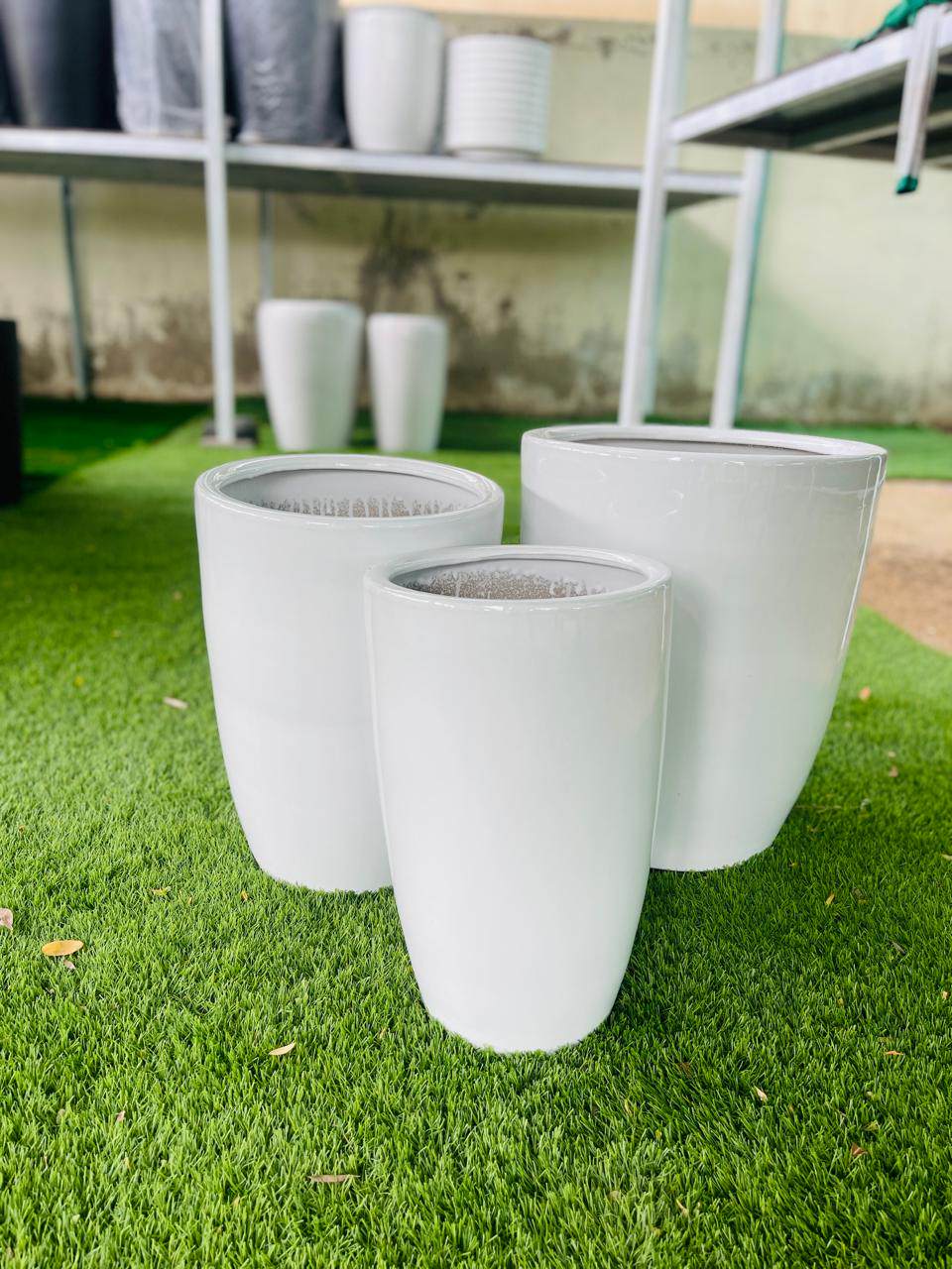 White ceramic tall planter pot, white cylindrical design (three pots shown)