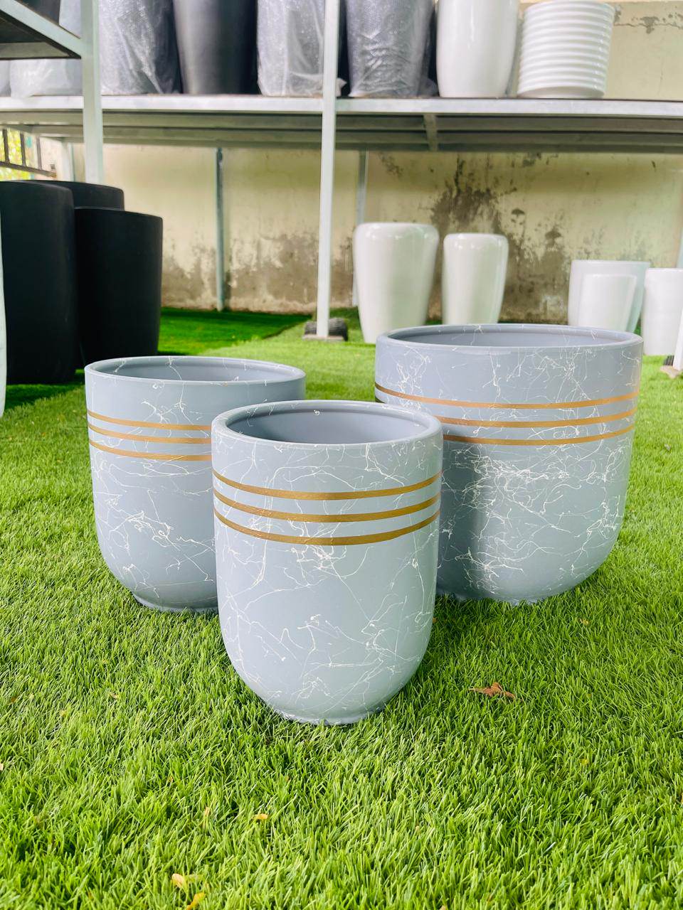 Set of ceramic sky blue planter pots with golden horizontal stripes