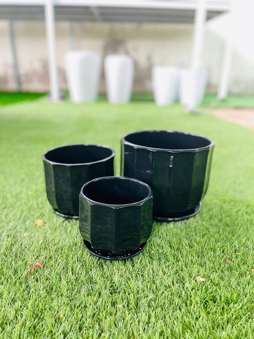 Set of three glossy dark ceramic low pots with open tops