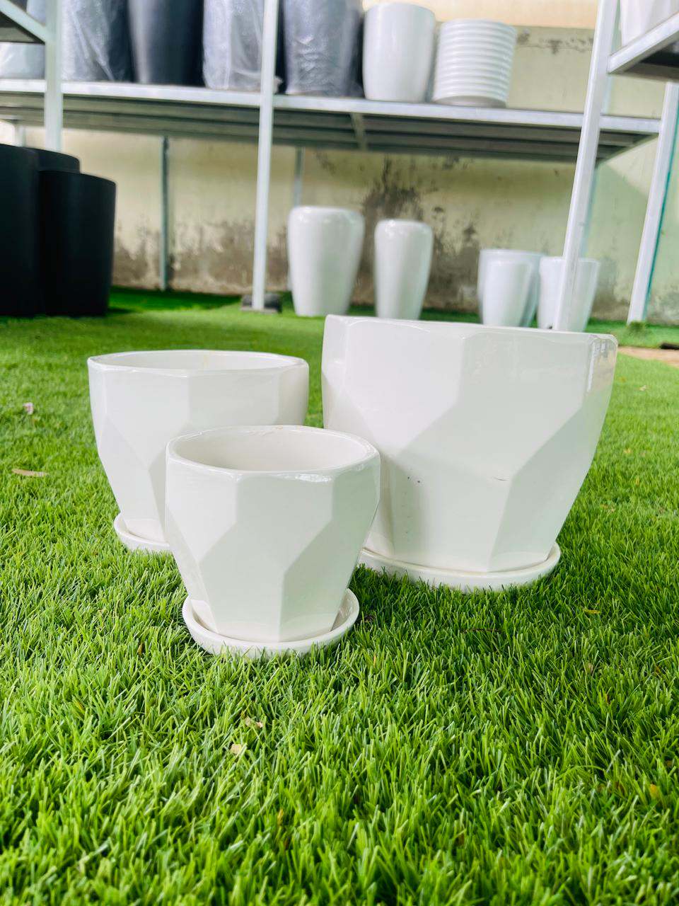 White ceramic low planter pots, wide rims, angled view, set of 3