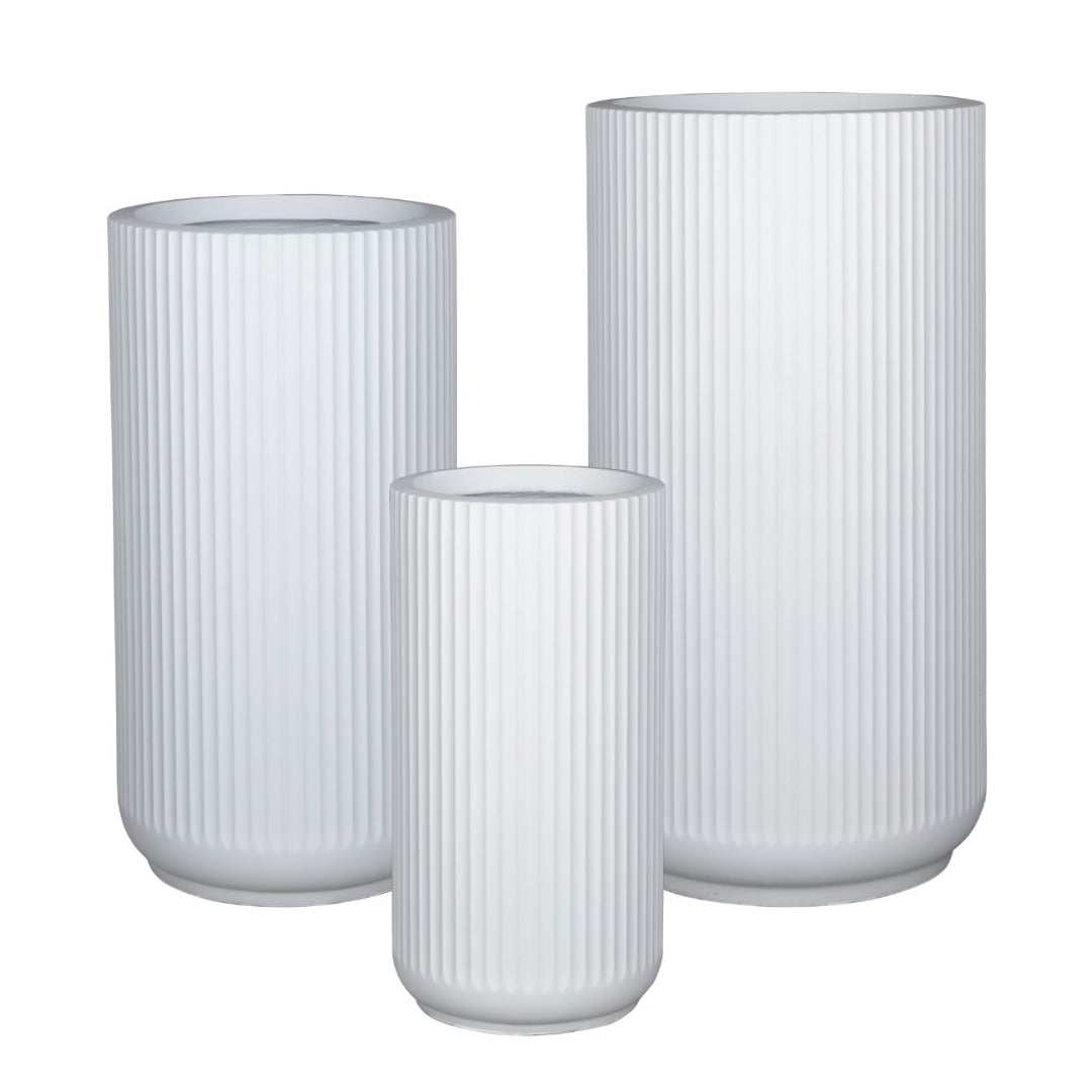 Set of three lined white fiber planters with vertical ribbed texture and round bases