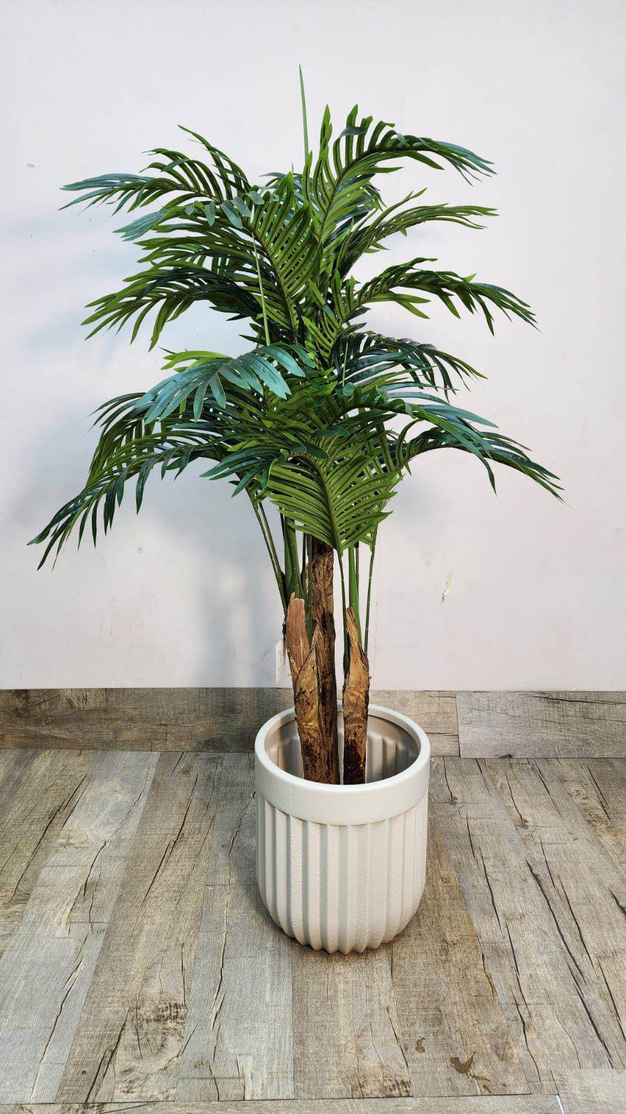 Artificial areca palm with green fronds in white ribbed pot, realistic stems