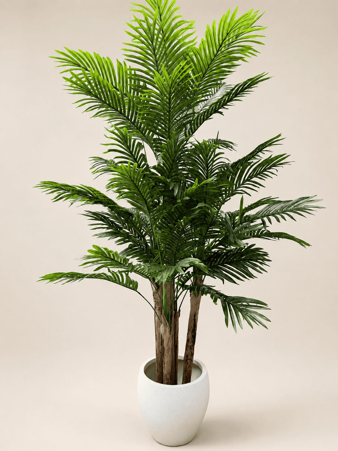 Artificial areca palm plant with green fronds in a white ceramic pot