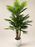 Artificial areca palm plant with green fronds in a white ceramic pot