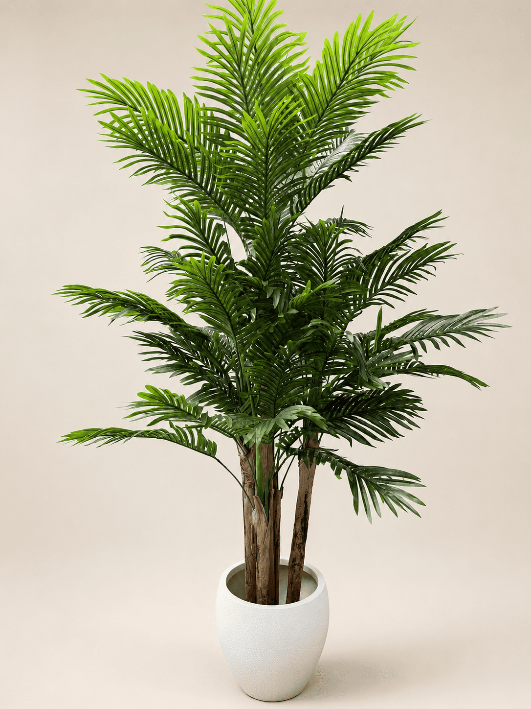 Artificial areca palm plant with green fronds in a white ceramic pot