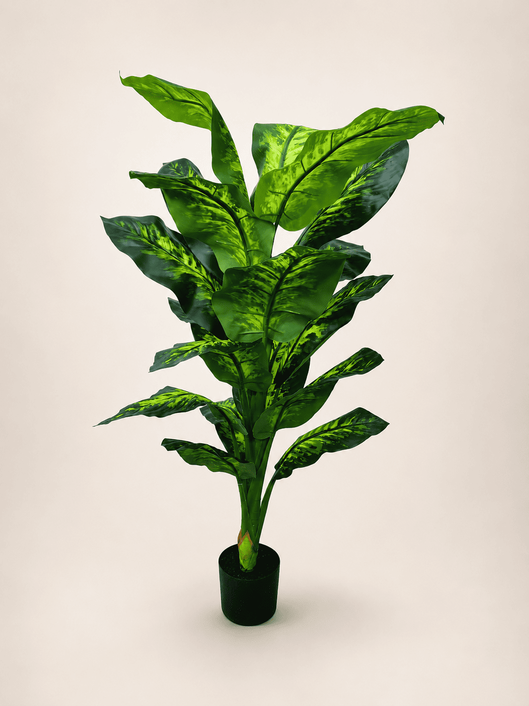 Artificial Dieffenbachia plant with bright green variegated leaves in a dark pot