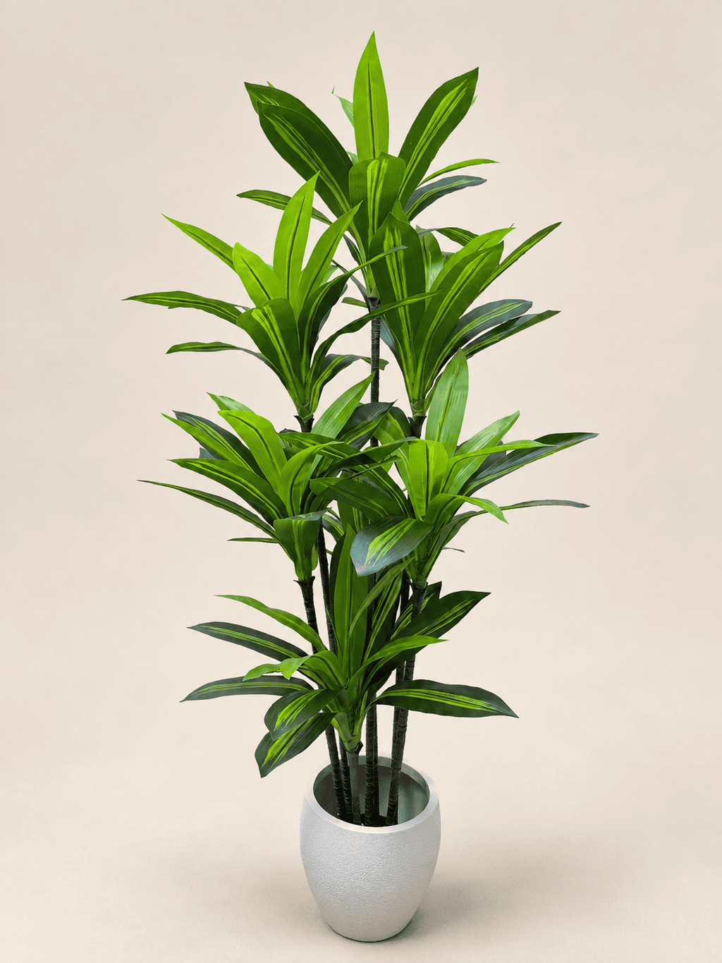 Artificial dracaena in light gray pot, tall stems with narrow green leaves