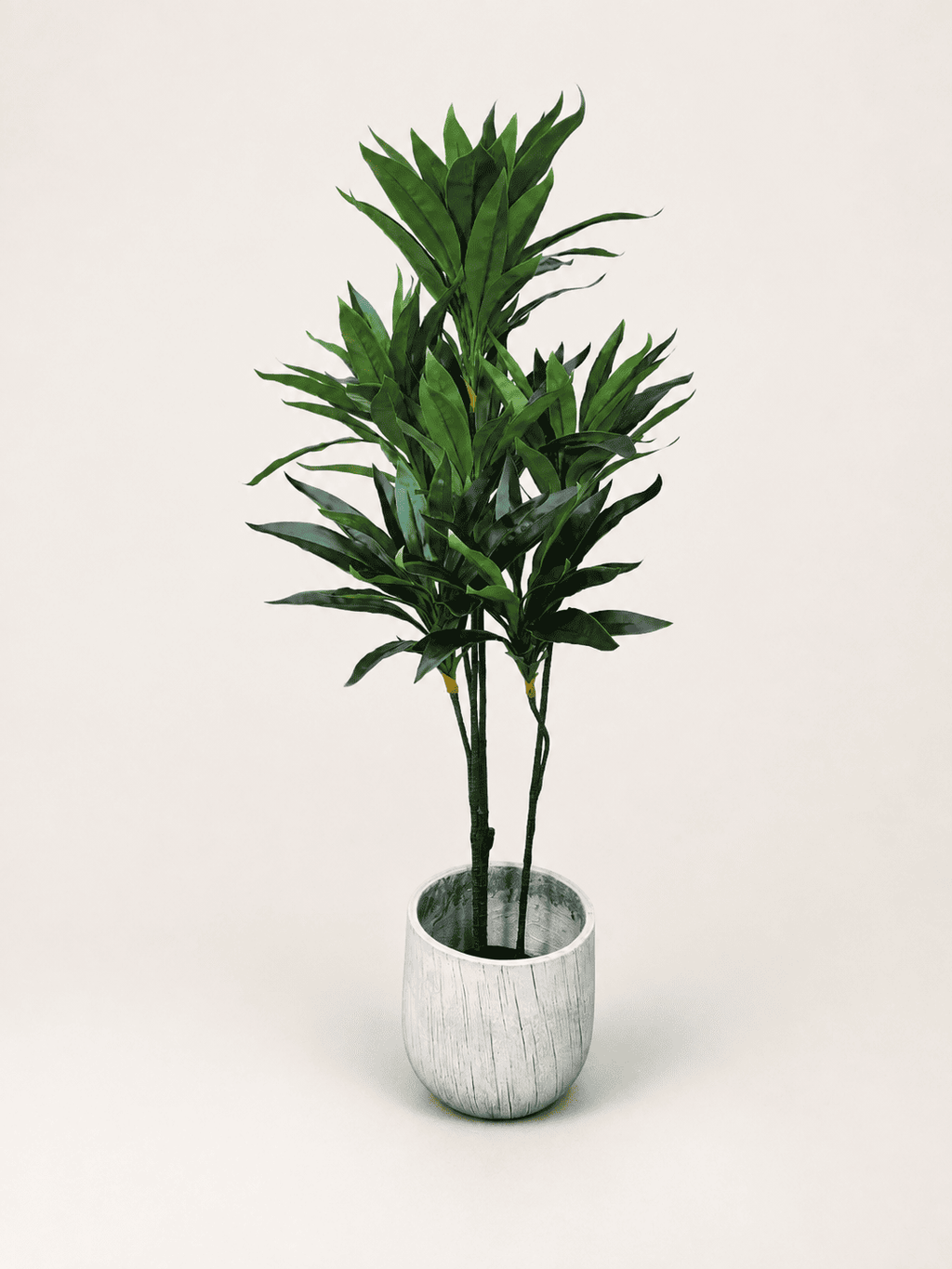 Artificial dracaena reflexa tree with green spiky leaves in light gray round pot