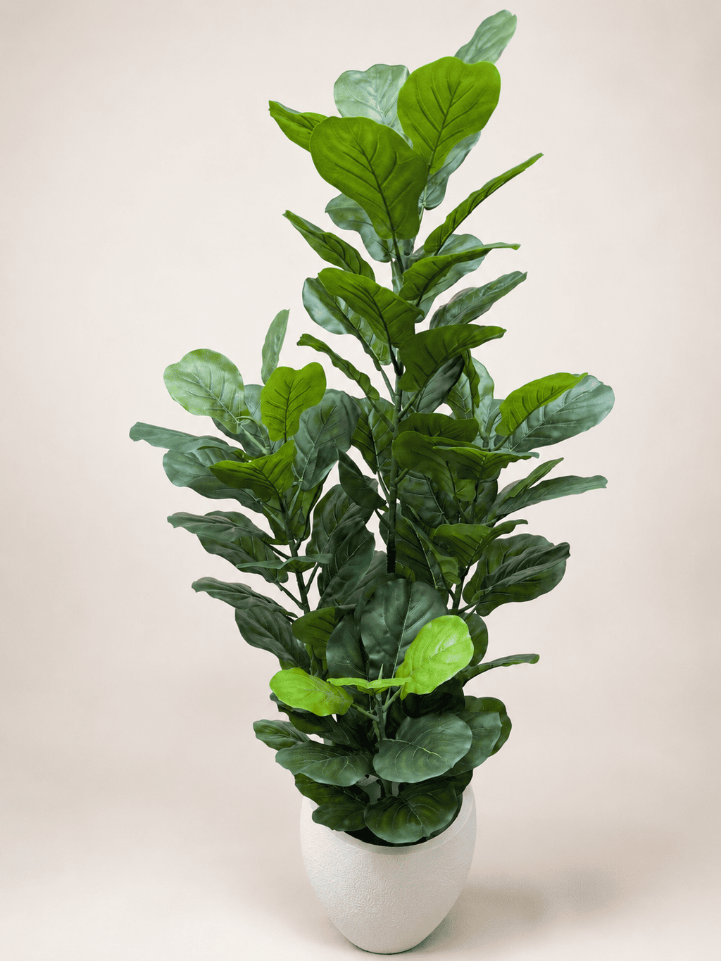 Artificial fiddle leaf fig tree with green lifelike leaves in a white ceramic pot