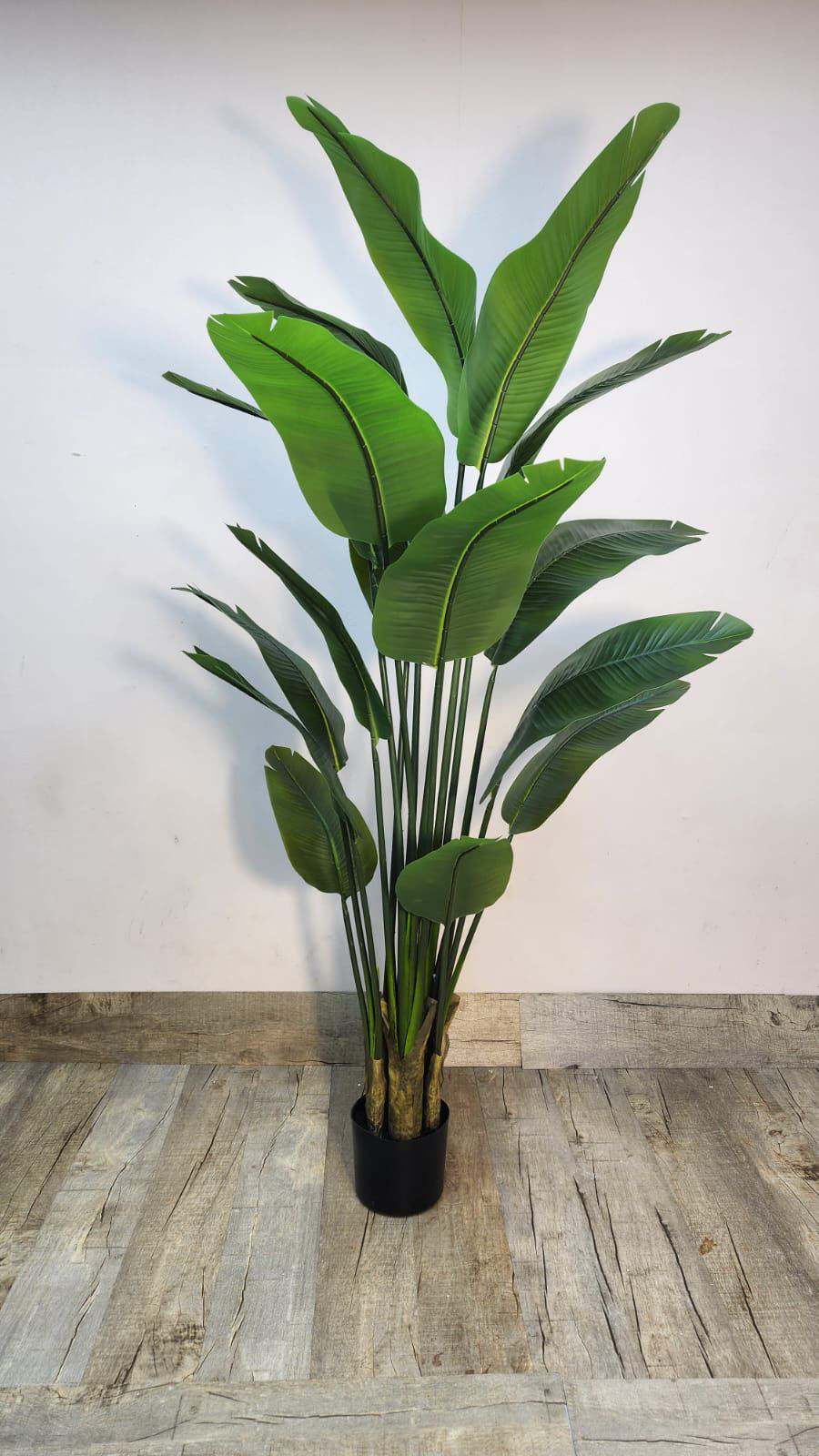 Artificial bird of paradise plant with green tropical leaves in black pot