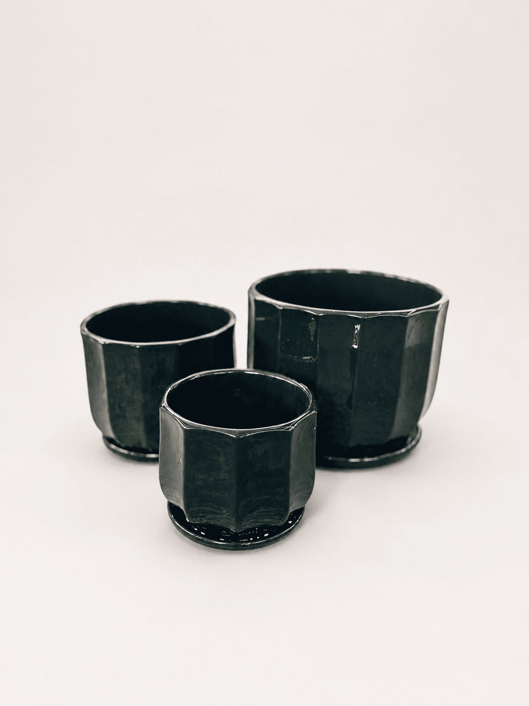 Set of three glossy ceramic low pots, dark black-green, square shape with flared rims