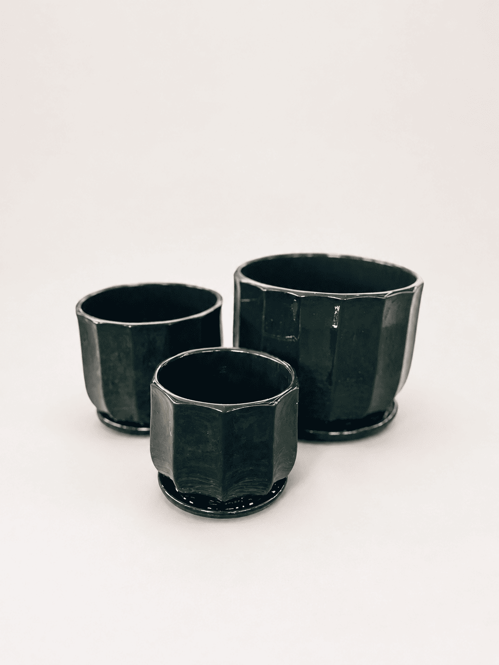 Set of three glossy ceramic low pots, dark black-green, square shape with flared rims