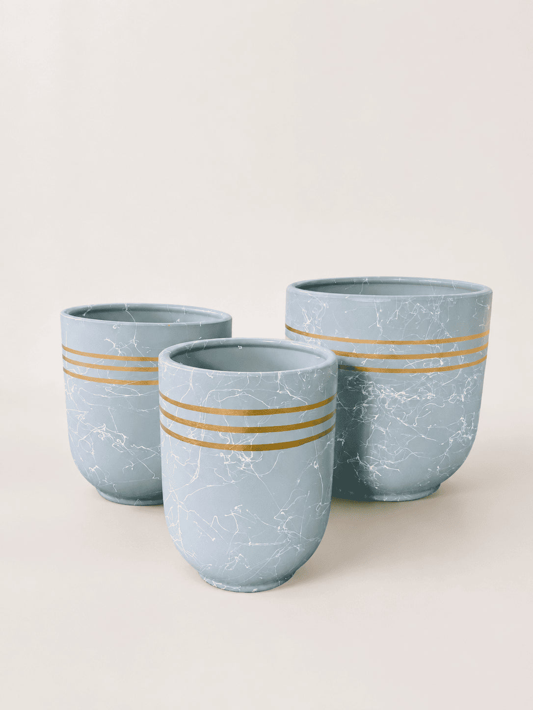 Sky blue ceramic plant pot with marbled finish and gold horizontal stripe