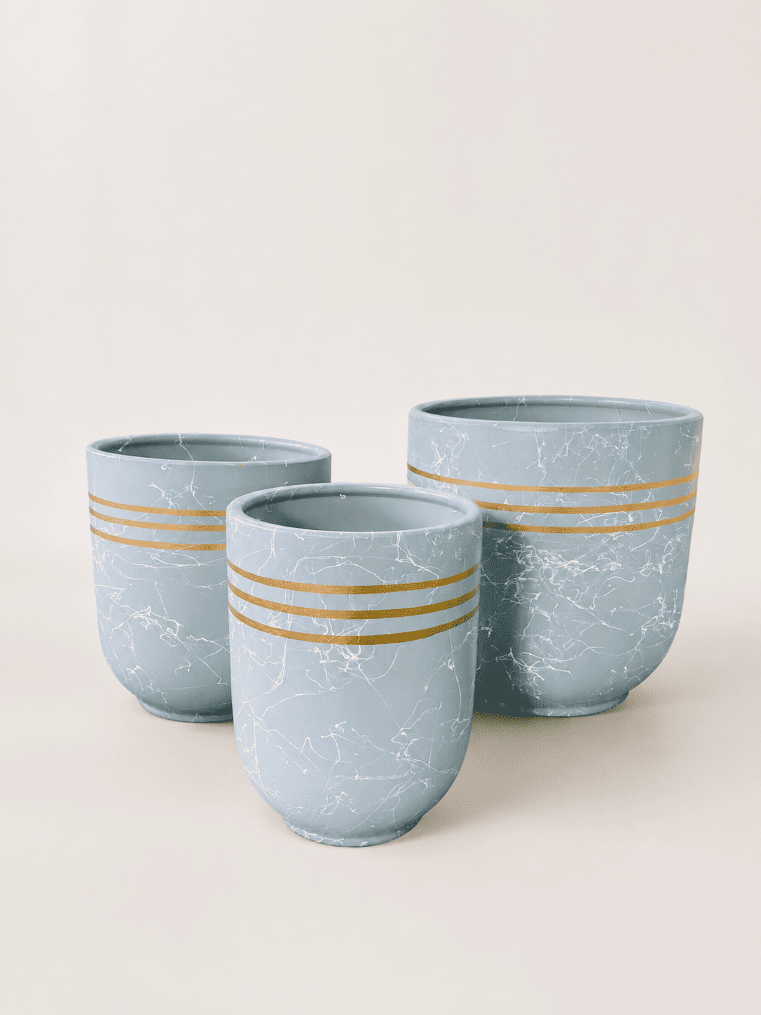 Sky blue ceramic plant pot with marbled finish and gold horizontal stripe