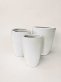 Set of three white ceramic tall planters with open tops