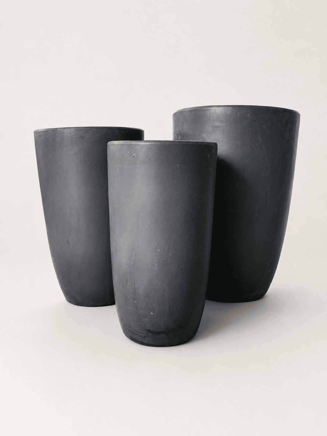 Matte black ceramic tall pots set of three, rounded flared rims, textured finish