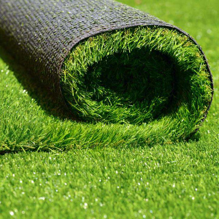 Artificial grass roll with bright green blades, shown cut end