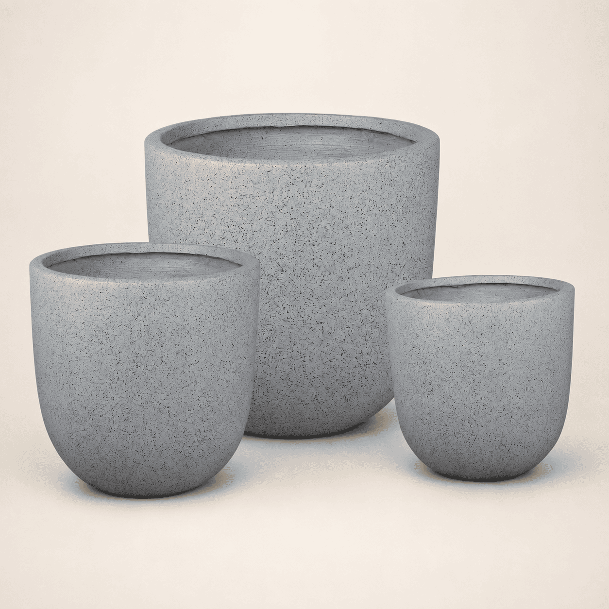 Set of three round grey planters with textured finish and open top