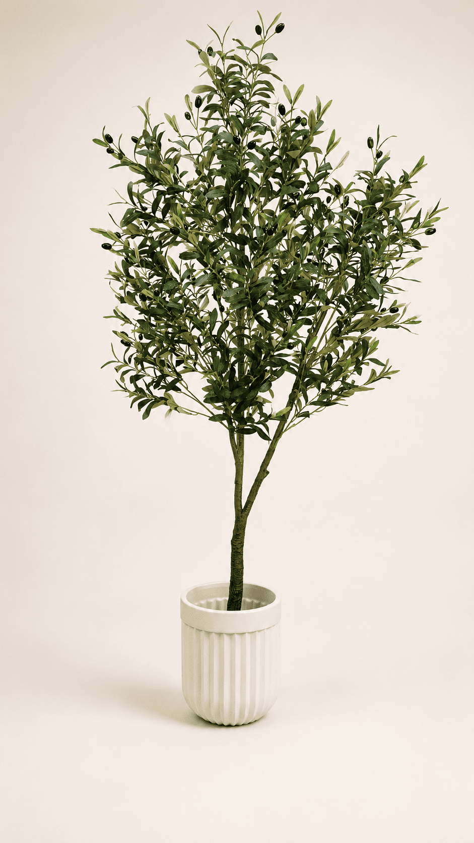 Artificial olive tree with green leaves in white ribbed ceramic pot