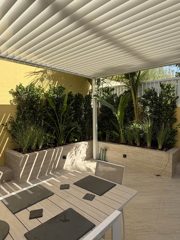 Shaded dining under a louvred roof