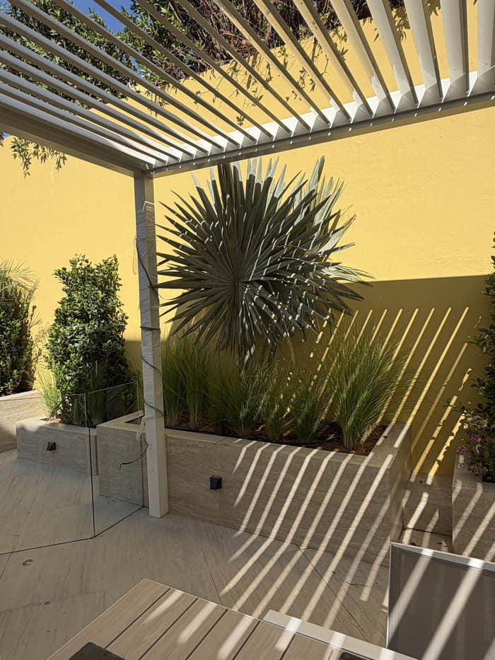 Louvred pergola over a terrace with raised planters in Dubai